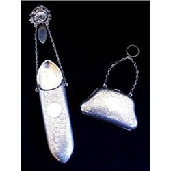 A FOLIATE ENGRAVED HOUSEKEEPER'S SPECTACLE CASE on twin suspension chains with scroll and shell belt