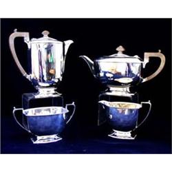 A PLAIN FOUR PIECE TEA SERVICE tea pot, water jug, sugar bowl and milk jug, raised on shaped foot, S