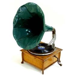 A VINTAGE HORN GRAMOPHONE the light oak rectangular case raised small shaped feet, with green horn,.