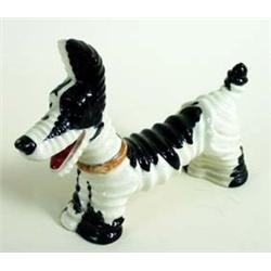 AN AMUSING CARLTONWARE BLACK AND WHITE DOG with all over ribbing, No 2600, 6.25  high £60-100...