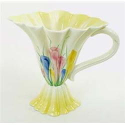 A CLARICE CLIFF SUNGLEAM CROCUS JUG of fluted trumpet shape on inverted matching foot, with scroll h