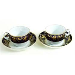 A PAIR OF NEW HALL CUPS AND SAUCERS bordered gold foliage on a blue ground (2) £60-100...