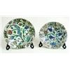 Image 1 : A 17TH CENTURY ISNIK POTTERY PLATE decorated stylised blue & red flora within a black scroll border,