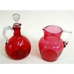 A VICTORIAN CRANBERRY GLASS JUG with clear glass strap handle, 6.5" high, together with a Victorian.