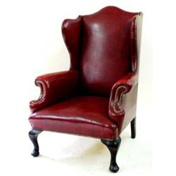 A GEORGIAN WING ARMCHAIR with scroll arms and cabriole front legs, upholstered in studded red leathe