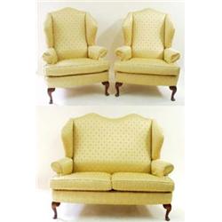 A THREE PIECE WINGED SUITE the two armchairs and settee with camel back, with scroll arms and cabrio