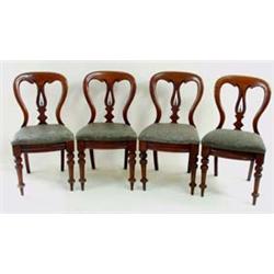 A SET OF FOUR LATE VICTORIAN MAHOGANY DINING CHAIRS with scroll carved crest rail and pierced and sh