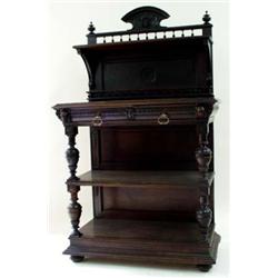 A LATE VICTORIAN DARK OAK BUFFET the back centred raised cresting with carved maskhead dividing fini