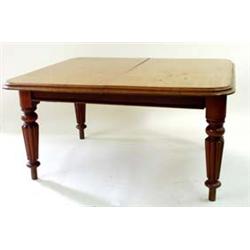 A VICTORIAN HONEY COLOURED MAHOGANY WIND OUT DINING TABLE the top with moulded edge over a plain fri