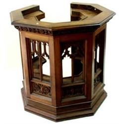 *A 19TH CENTURY SEVEN SIDED OAK PULPIT the top with moulded edge over a foliate carved frieze and pi