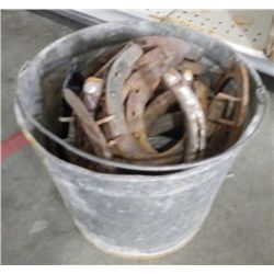 Galvanized bucket full of horse shoes