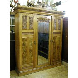 A Victorian satinwood triple wardrobe