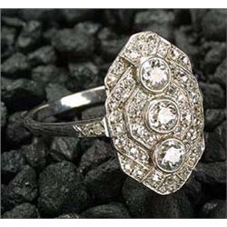 An Art Deco diamond panel ring, with a central old-cut diamond three stone line within a diamond sli