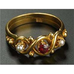 An early 20th century gold, garnet and half-pearl three stone ring, centred with a small round mixed