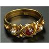 Image 1 : An early 20th century gold, garnet and half-pearl three stone ring, centred with a small round mixed