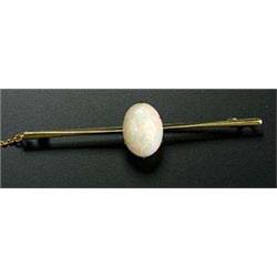 An early 20th century gold and opal single stone bar brooch, the oval white opal claw set on a knife
