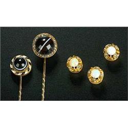 Two Victorian gold and sard-onyx round stick pins, one with a rose diamond border, the other with a.