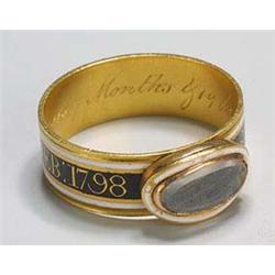 An 18th century gold and enamel memorial broad-band ring, the front with a raised oval hair glazed p