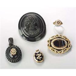 A group of 19th century mourning jewellery, comprising; a gold shaped-oval mourning brooch,  centred