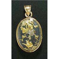 A 19th century Japanese Shakudo and gilt metal oval locket, the front and back set with oval Shakudo