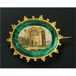 A Victorian gold and micromosiac oval brooch depicting classical ruins on a malachite ground, set in