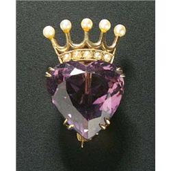 An early 20th century gold, amethyst and pearl brooch in the form of a crowned heart, the large amet