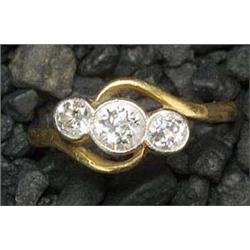 A diamond three stone cross-over ring, the graduated old-cut stones approx. 1.06cts total, rub-over.