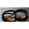 A pair of Victorian tortoiseshell pique and coral bangles, the tapering bands each set with an oval.