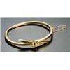 An Edwardian gold, half-pearl and diamond hollow hinged bangle of square section cross-over design,.