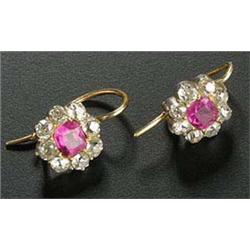 A pair of early 20th century ruby and diamond cluster earrings, each centred with cushion shaped rub