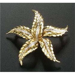 A modern 18ct gold and diamond flower head brooch, the five textured yellow leaves each with a centr