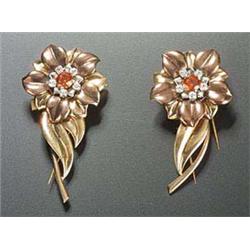 A pair of 'cocktail' style clips in the form of stylised flowers, each centred with an orange and wh