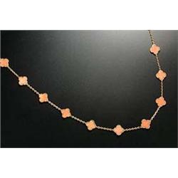 A Van Cleef and Arpels, French 18ct gold and coral necklace, the 20 coral quatrefoil-shaped panels w