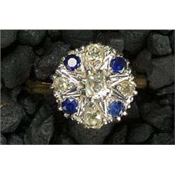 A sapphire and diamond cluster ring, the round head centred with an old-cut diamond within an altern