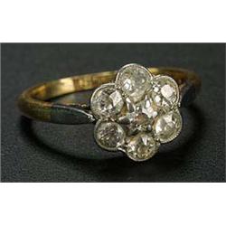 A diamond seven stone flower head cluster ring, the old-cut stones approx, 0.60cts total, millegrain
