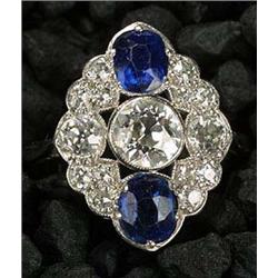 An early 20th century sapphire and diamond cluster ring of shaped-oval outline, centred with an Edwa