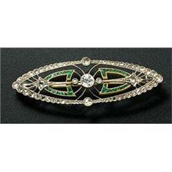 An Art Deco emerald and diamond marquise shaped brooch, the openwork panel millegrain set at the cen