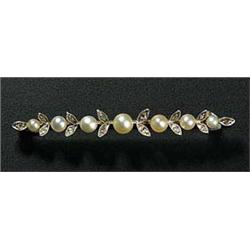 An early 20th century gold, pearl and diamond bar brooch in the form of seven graduated bouton pearl