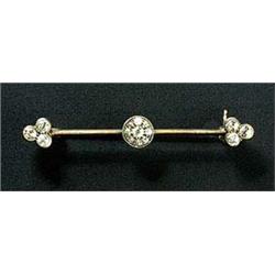 An Edwardian diamond bar brooch, with a central cluster and trefoil terminals, set in silver and gol