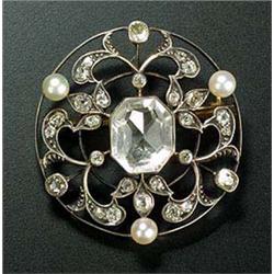 An Edwardian diamond, pearl and paste openwork round brooch, centred with a canted rectangular facet