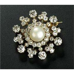 A late Victorian diamond and pearl cluster brooch in the form form of a snowflake, centred with a pe