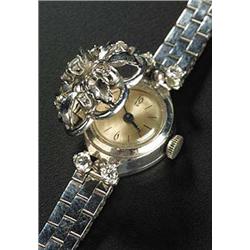 A lady's Continental white metal and diamond wristwatch with hinged cover, circa 1970, no.4675, sati