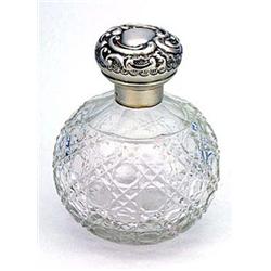 A cut-glass and silver mounted spherical scent bottle, the hinged cover embossed with scrolls on a m
