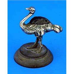 A pin cushion in the form of an ostrich, standing on a round composition base, Birmingham 1911 by Le