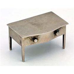 A silver stamp box in the form of a serpentine side table, with a hinged lid, one dummy drawer on sq