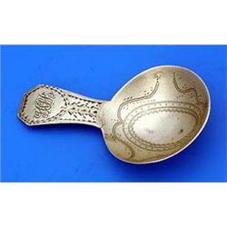 A George III caddy spoon with wriggle engraved round bowl and bright-cut engraved handle with monogr