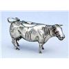 A Dutch cow creamer, the head with ruby-glass eyes, the hinged cover with a fly finial, the curling.