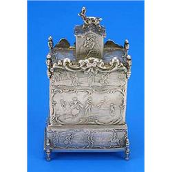 A Dutch cabinet-shaped tea caddy, embossed with figures and foliate scrolls, the cover with an anima