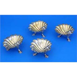 A set of four George III shell bowl salt cellars with crests each on three hoof feet, London 1794 by