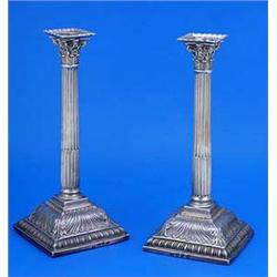 A pair of early George III candlesticks, the stop-fluted columns with pierced corinthian capitals an